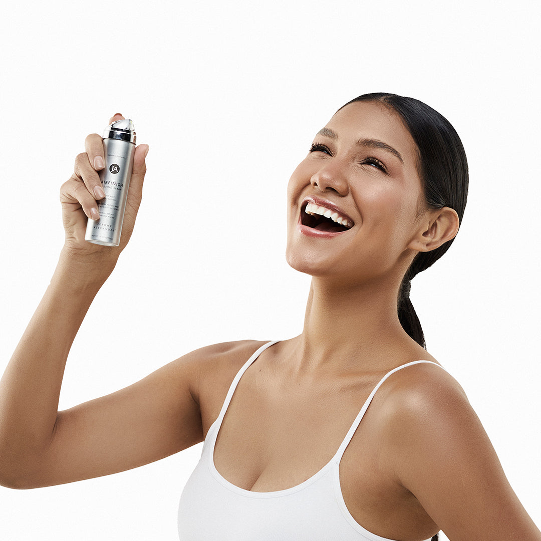 Model holding a can of AirFinish Setting Spray